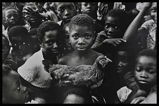 Ghana, boy with chicken.