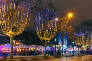 Festively decorated and illuminated Champs Elysees and Christmas market at night, France