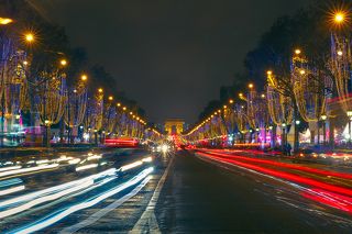 Festively decorated and illuminated Christmas Champs Elysees and Arc de triomphe Paris at night, France