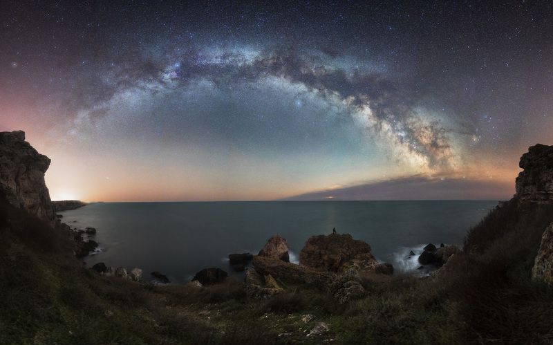 April panorama with the Milky Way and moon rise hidden behind the clouds