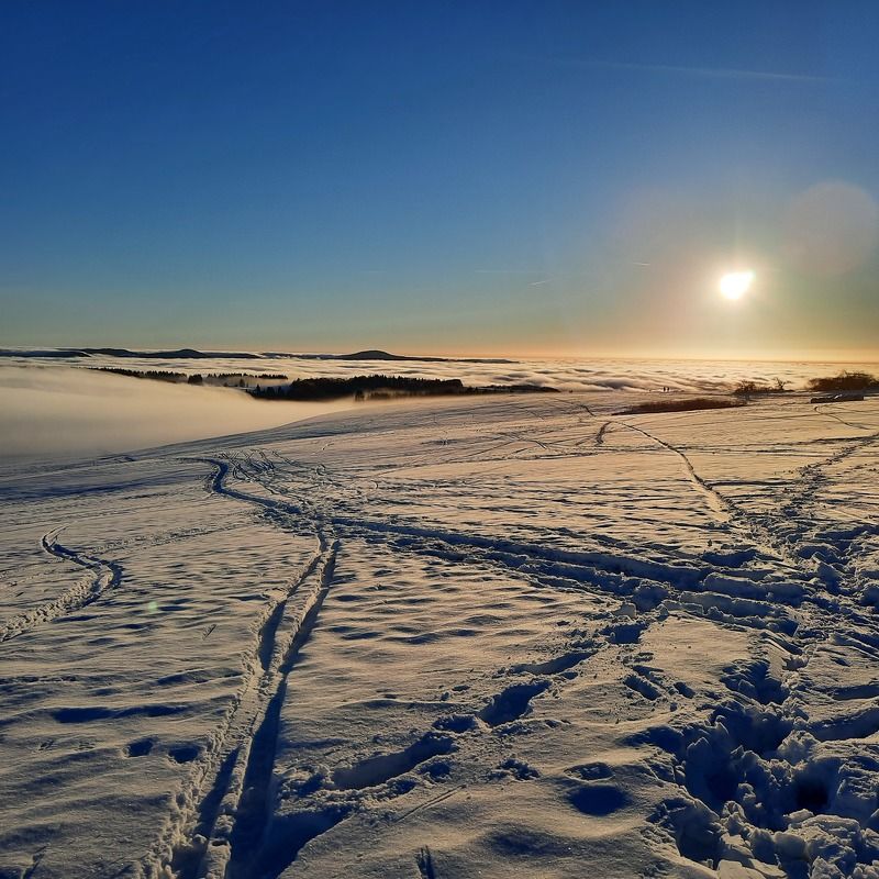 sunset in the snow and fog on top of winter mountain Rhoen Rhön Hesse Germany
