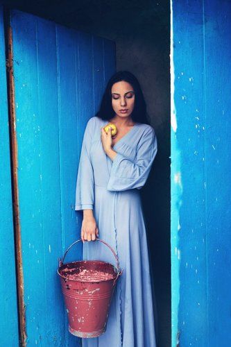 Woman in blue with apple