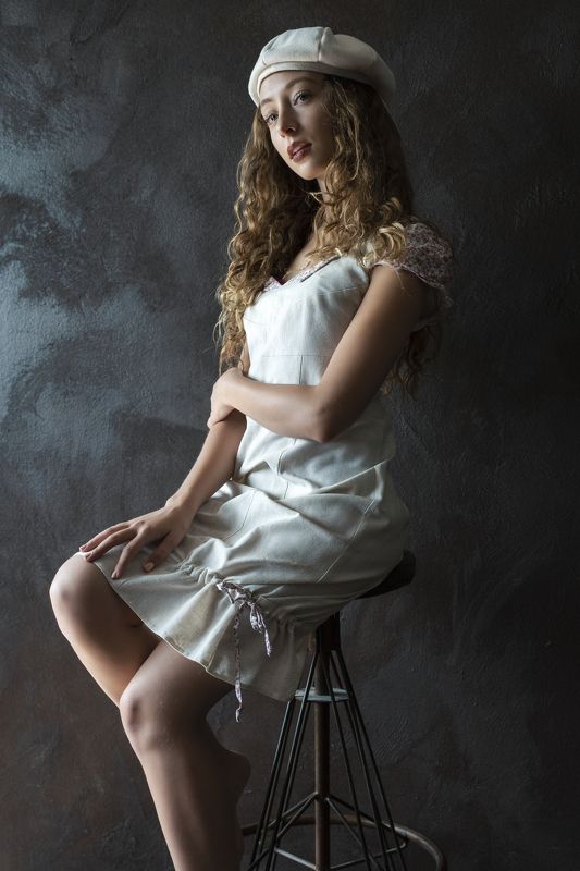 attractive, beautiful woman, beauty, beret, blonde, casual clothing, chair, dreaminess, dress, fashion, female, girl, hair, hands, human face, individuality, indoors, lips, looking, one person, portrait, side view, sitting, stool, studio shot, young woman Girl with a White Beretphoto preview