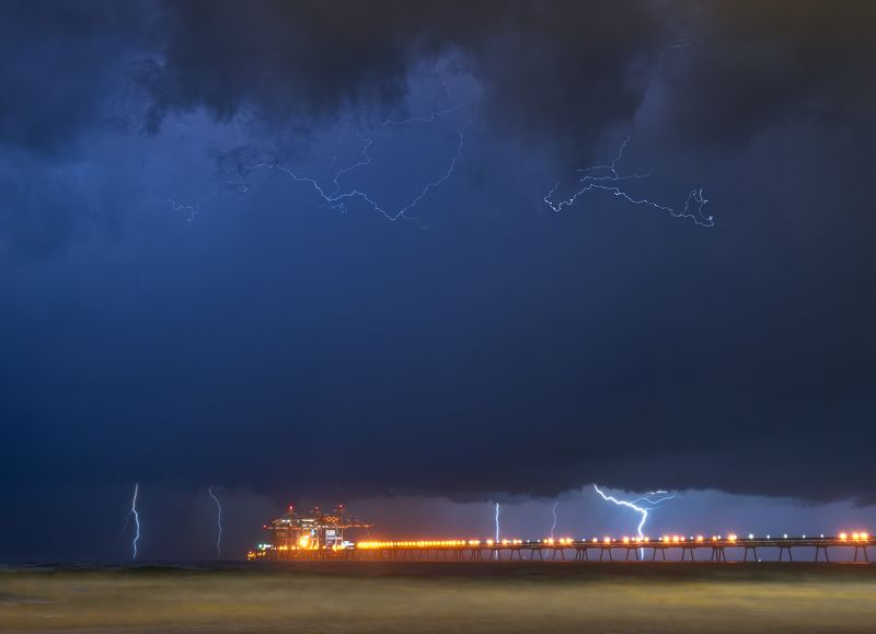 Lightning over power station