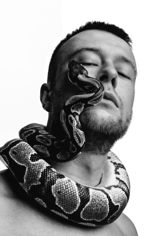 Black and white style portrait of man with snake face