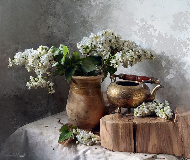 With white lilac and brass teapot