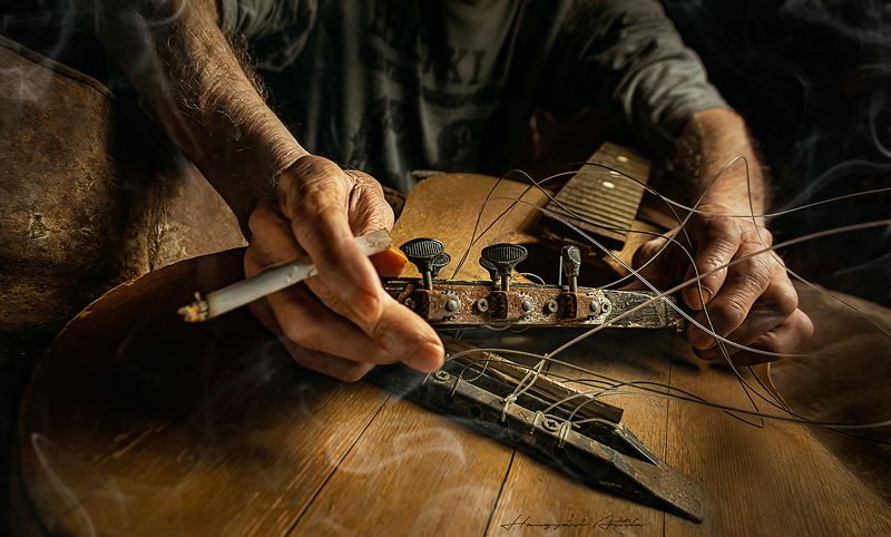 Hands and broken guitar III.