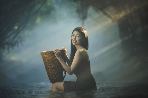 Asian girl take a bath in river