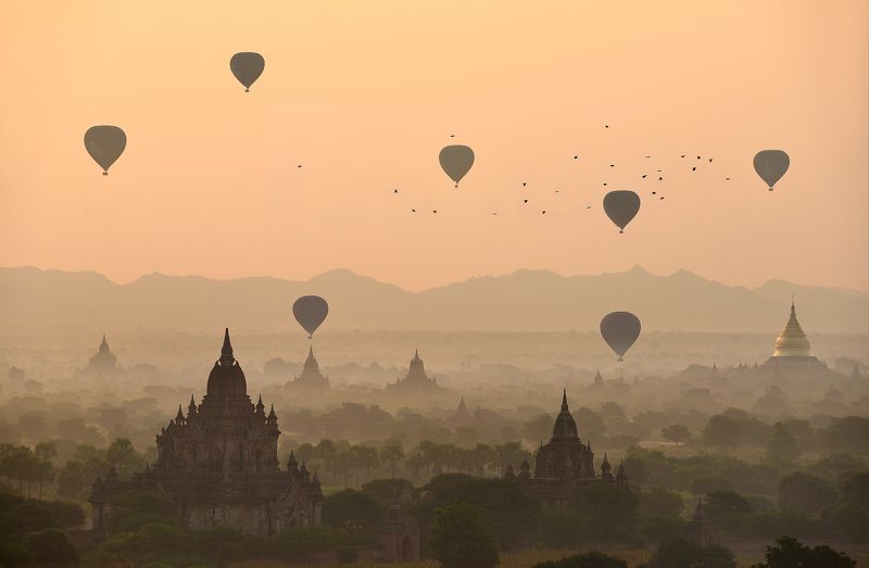 Adventure Ancient Architecture Bagan Built Structure Color Image Dawn Dusk Flying Fog Horizontal Hot Air Balloon Landscape Mandalay Division Mid-Air Myanmar Nature No People Old Ruin On The Move Orange Color Outdoors Photography Religion Scenics Silhouett Balloons over the temples of Baganphoto preview
