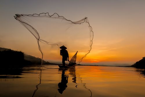 Silhouette of asian fisherman.