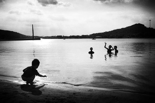 Children playing by the lake